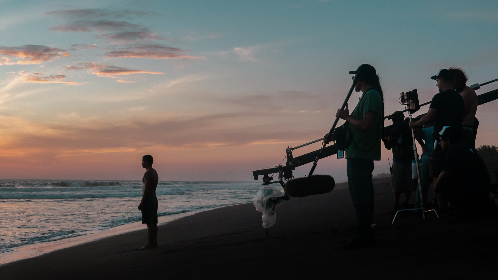 Arena Negra crew filming on the beach at sunset